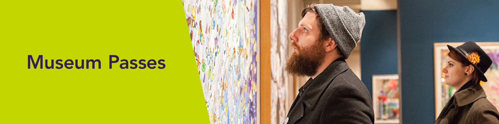 DESIGN-HEADER-banner-museum-passes A bearded man and woman in a hat view art exhibits