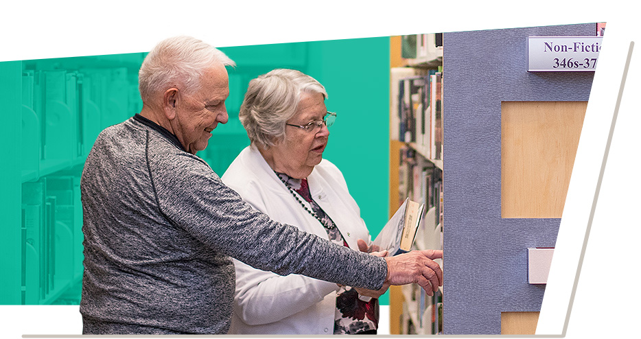 Older Adults browsing a selection of library books
