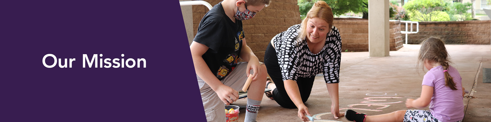 DESIGN-HEADER-banner-our-mission A family playfully use sidewalk chalk