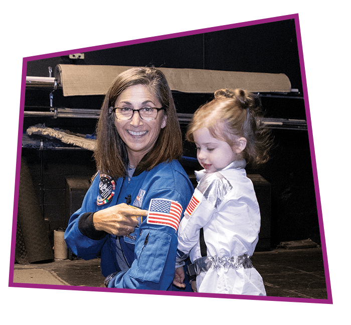 Astronaut Nicole Stott meets with a little girl